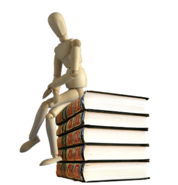 Art mannequin sat on a pile of books